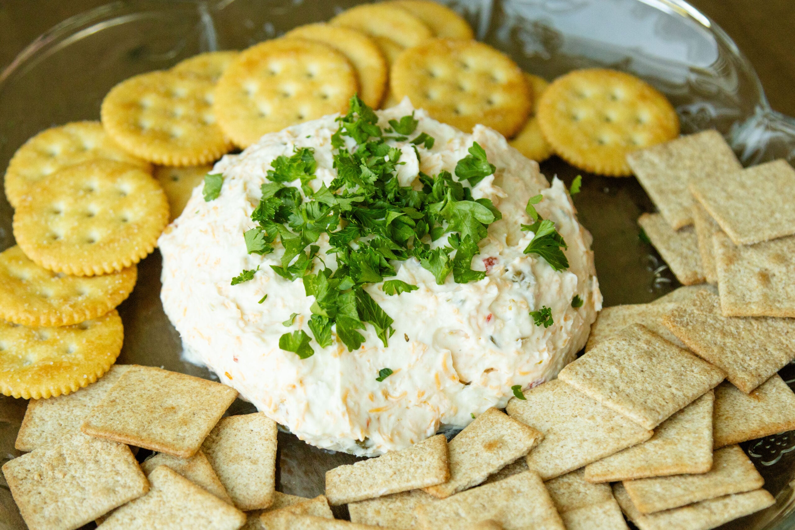 cheese ball on a platter with crackers