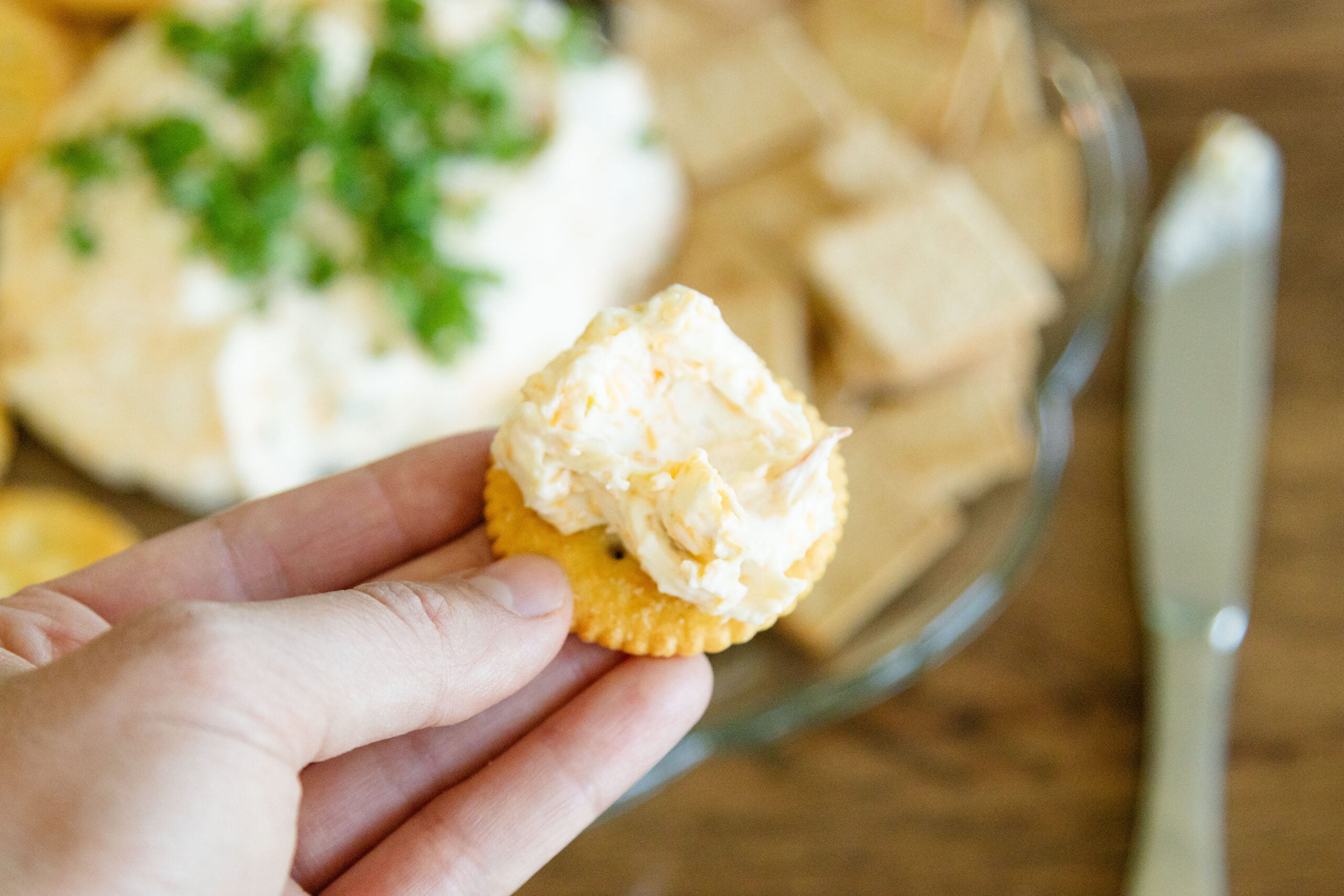 a serving of cheese ball on a cracker