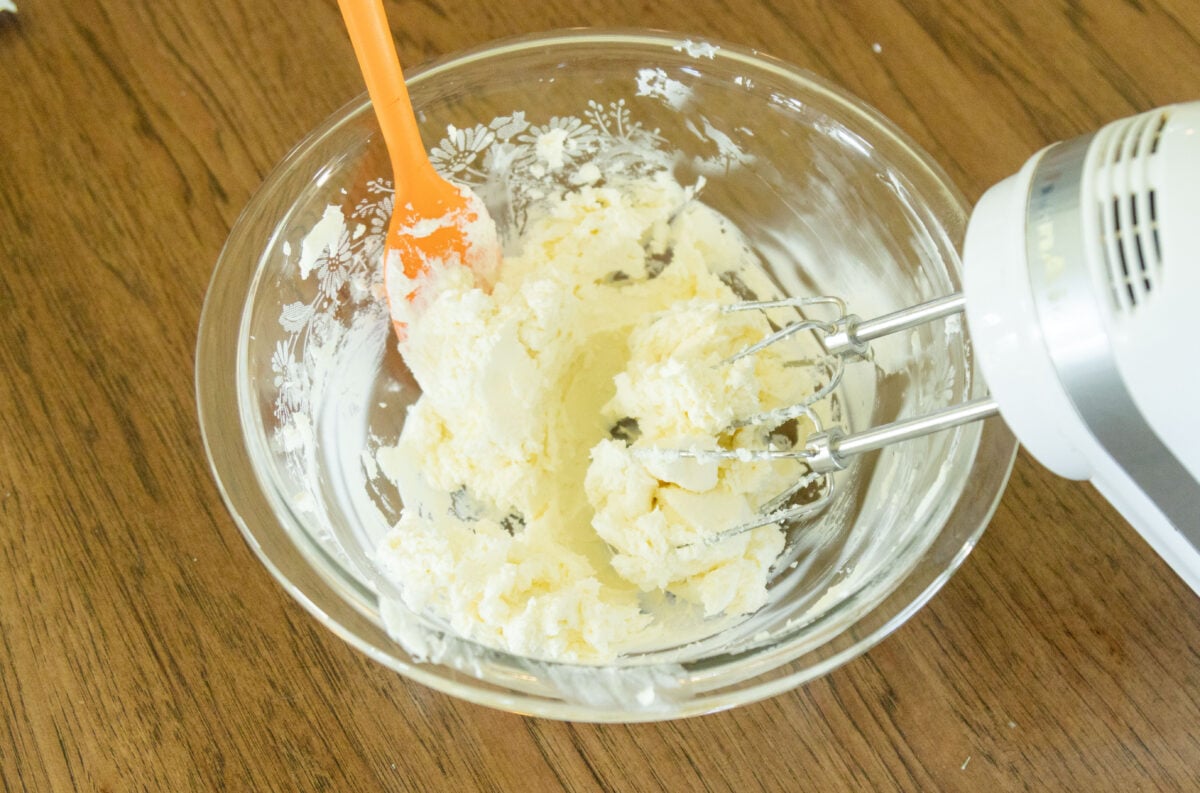 beating the cream cheese in the bowl