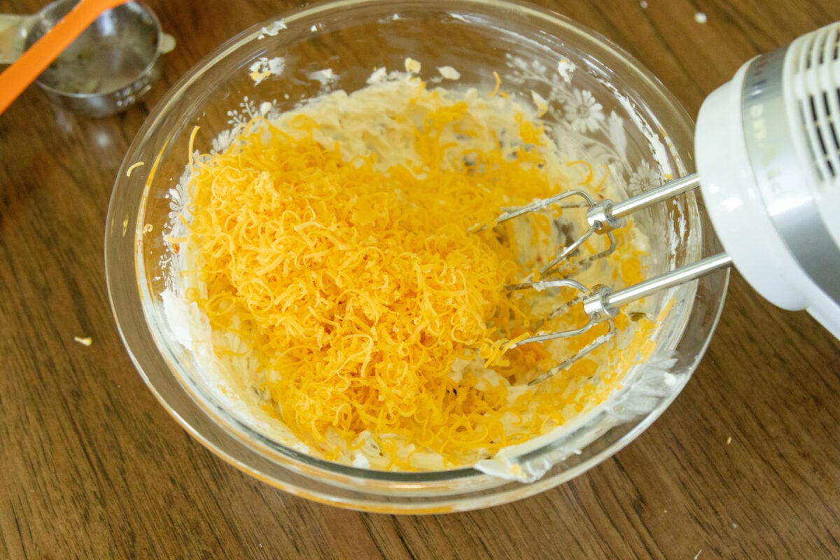shredded cheese in the mixing bowl with the cream cheese mixture