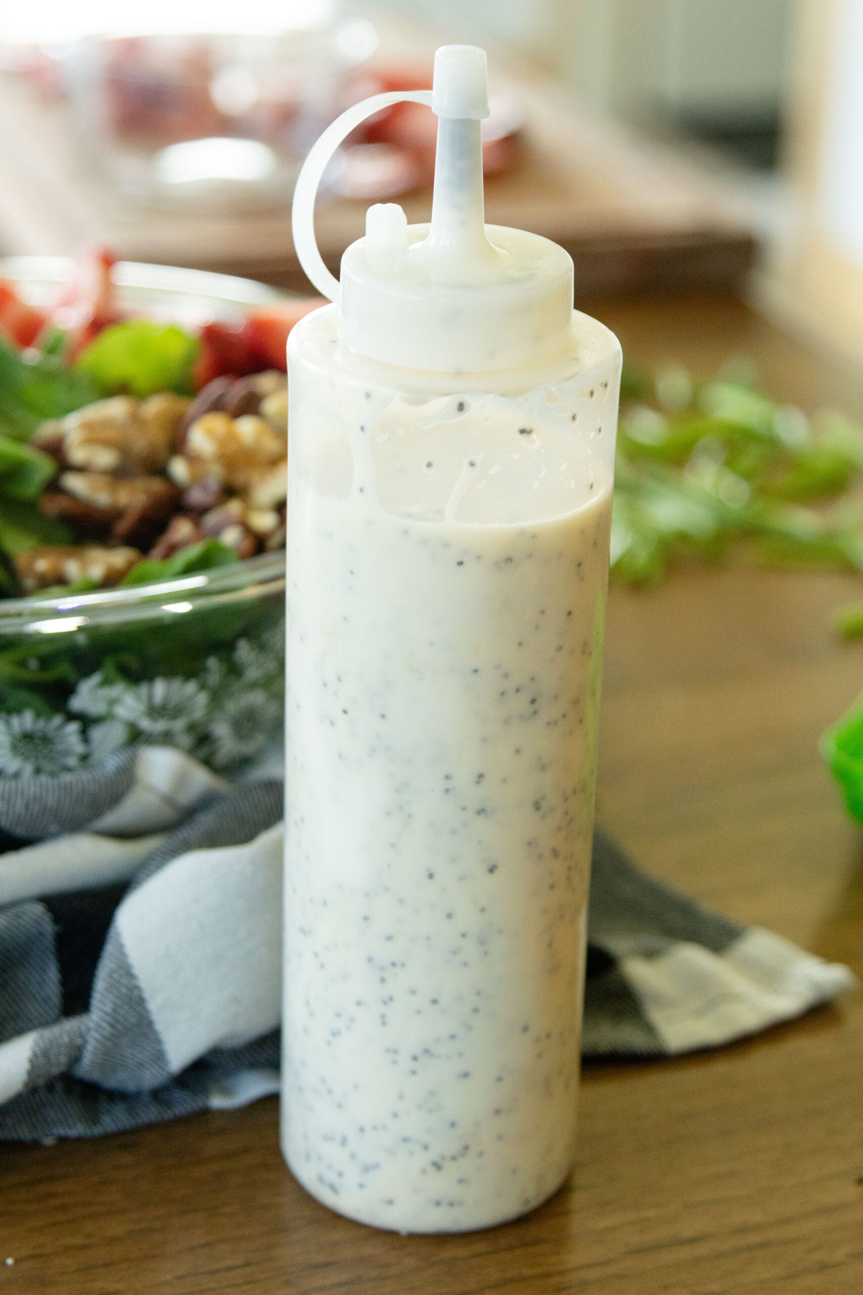 a bottle of homemade poppy seed dressing on the table