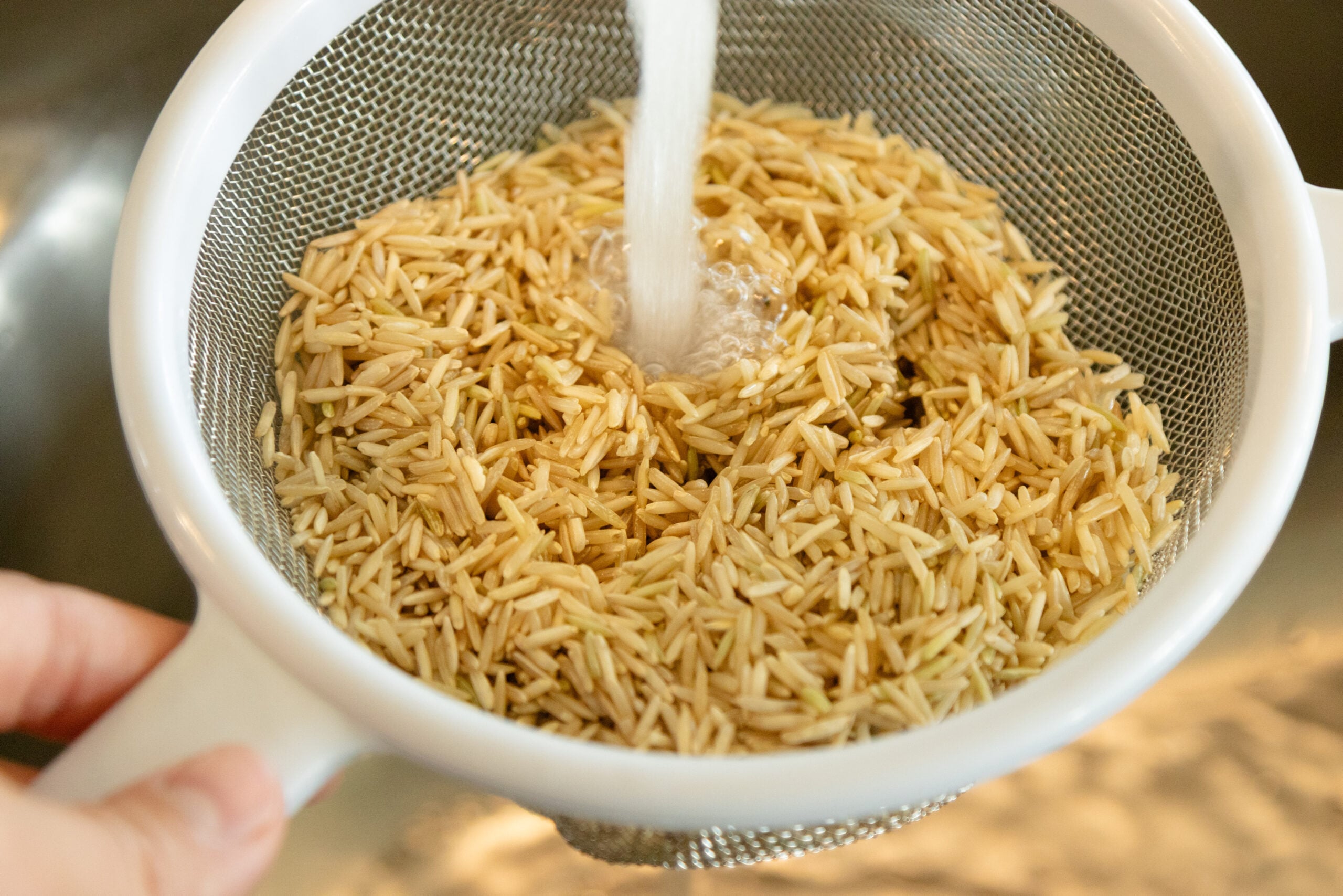 rinsing the rice under cold water
