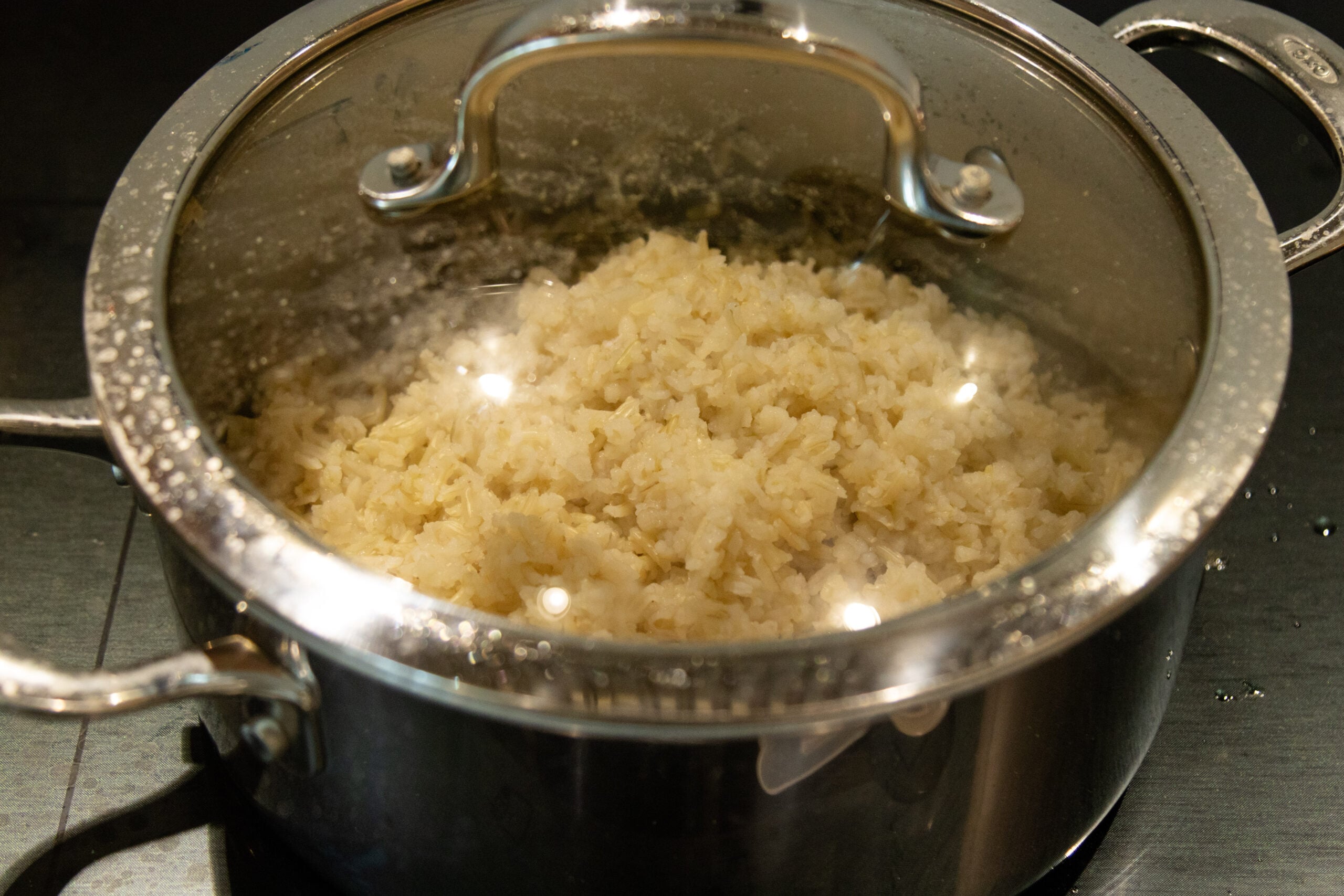 fluffy brown rice in the pot with the lid on