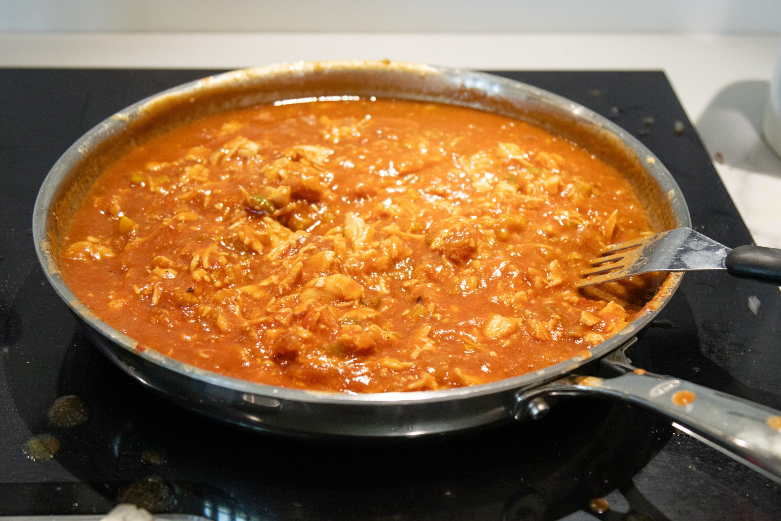 stirring the chicken creole together