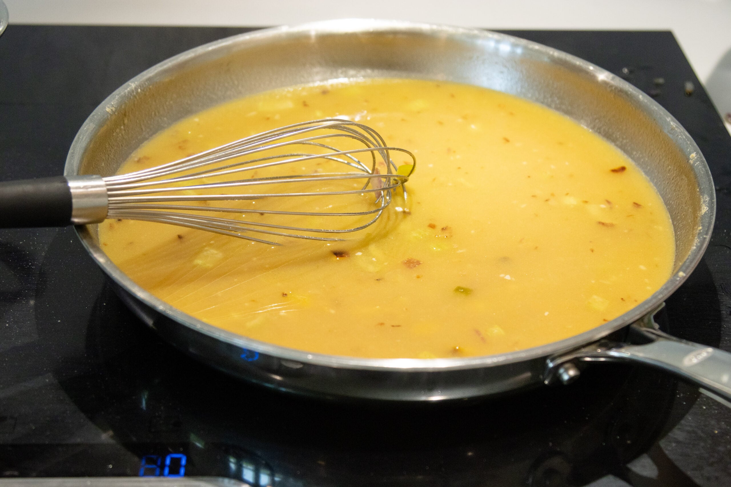 whisking in the chicken broth