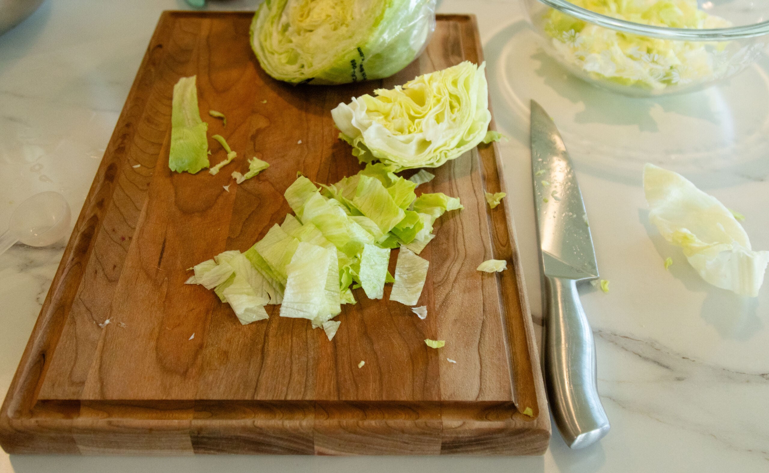 chopping the lettuce on the cutting board