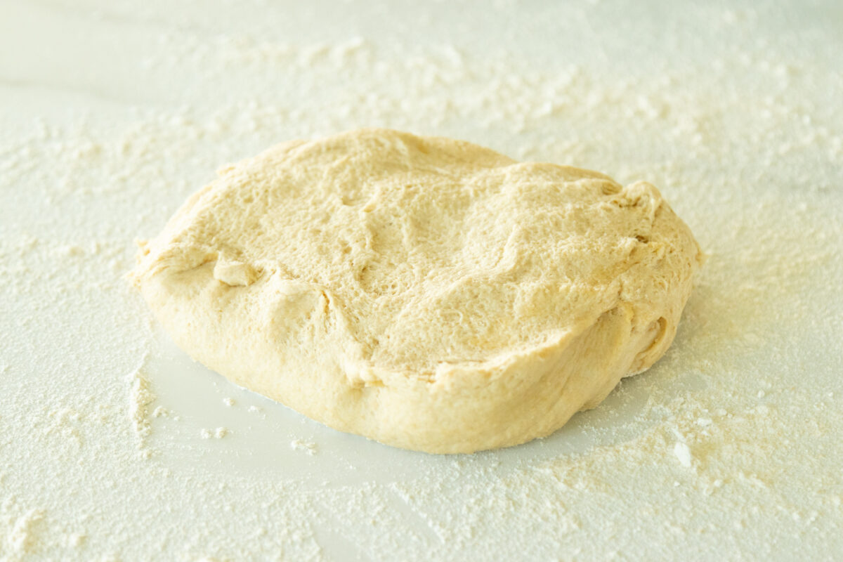pizza dough on a floured surface