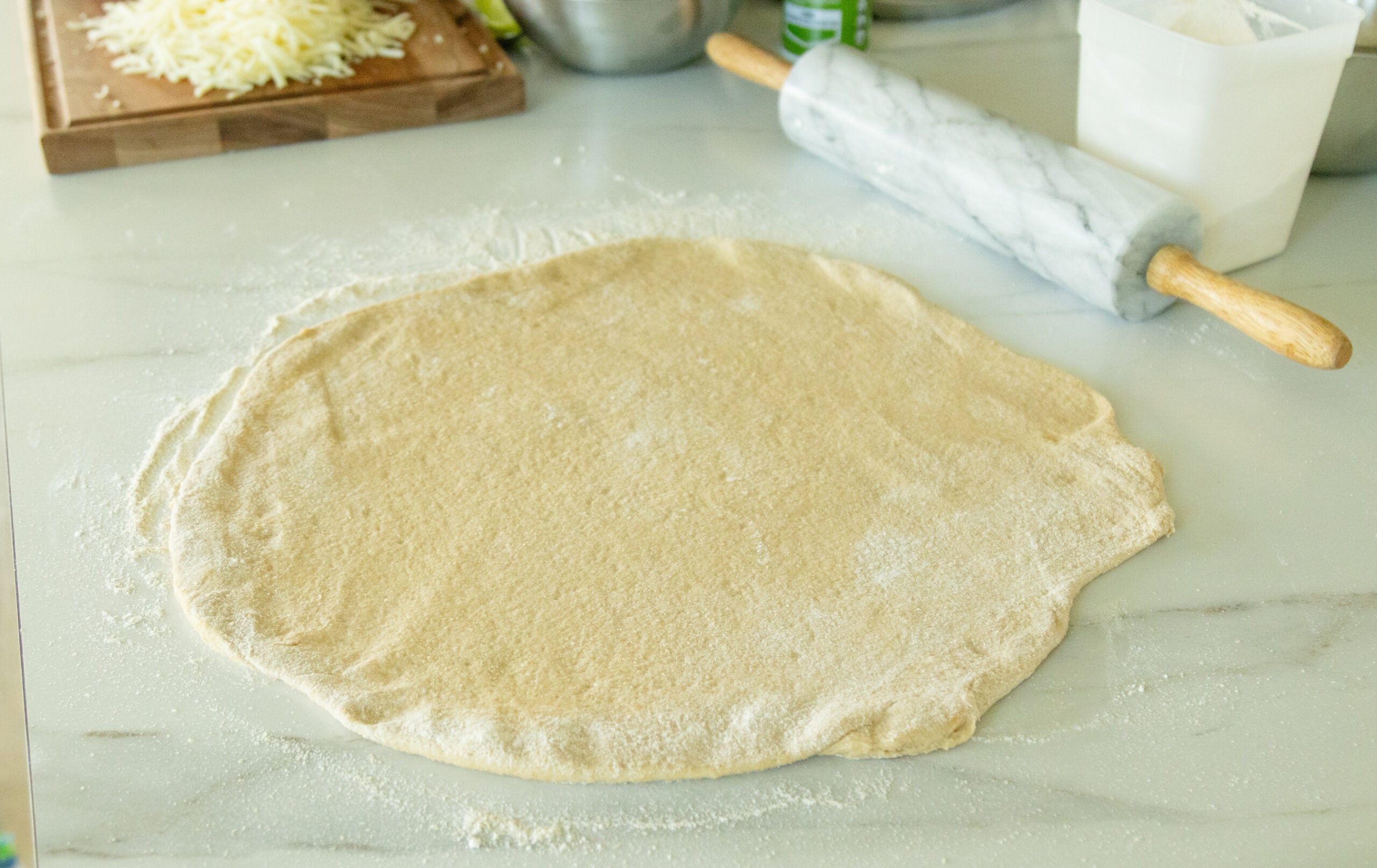 rolled out pizza dough ready to be trasferred to the pan