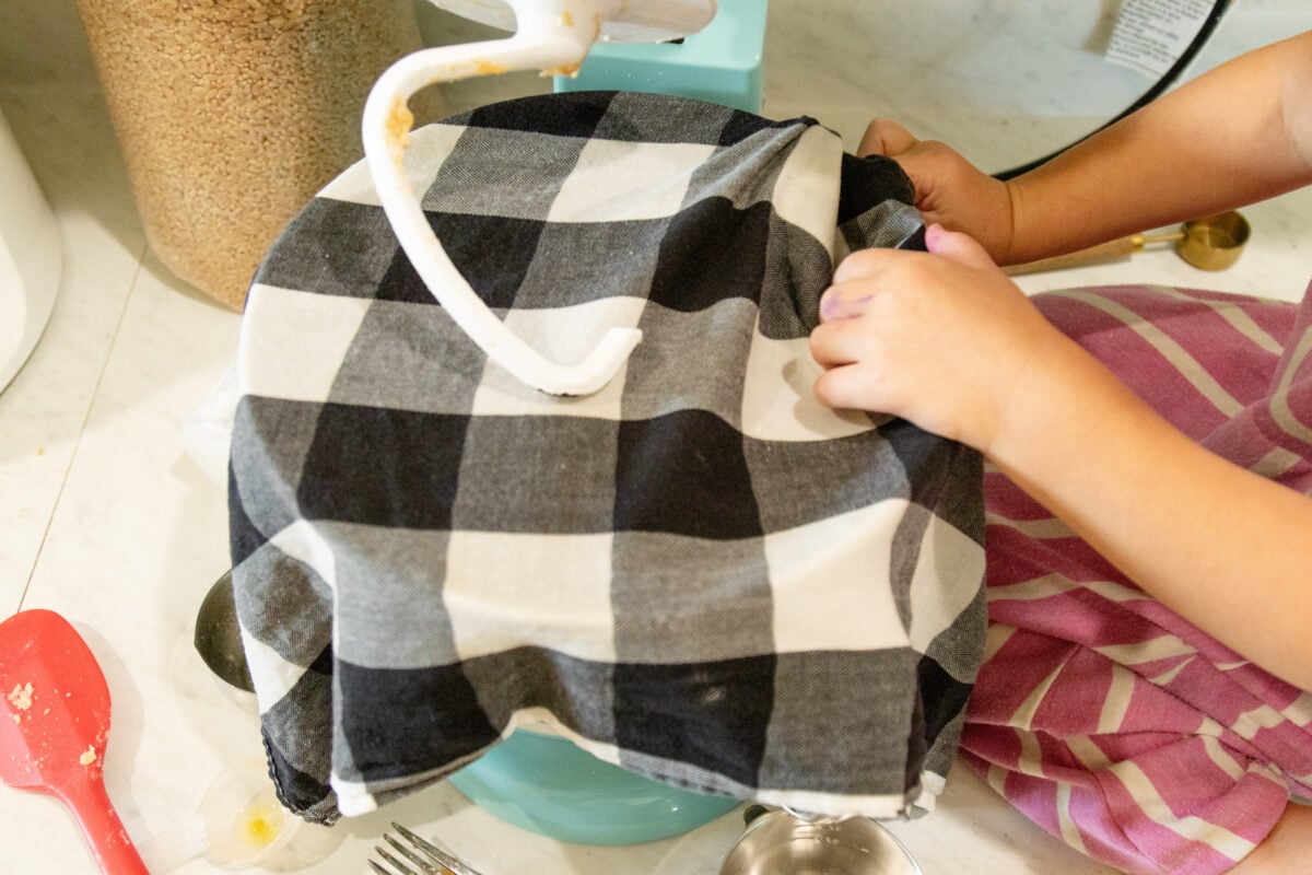 covering the mixing bowl with a black and white checkered cloth