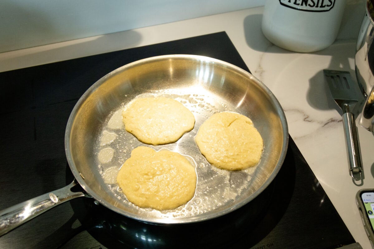 three pancakes frying in a pan