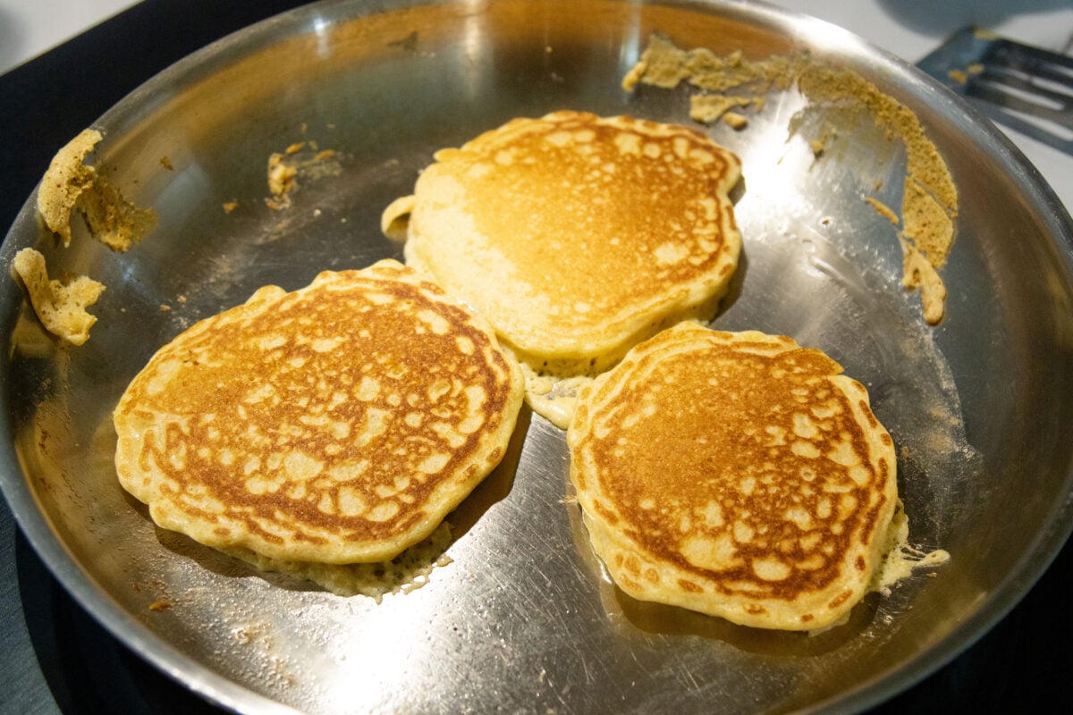 three pancakes frying in the pan