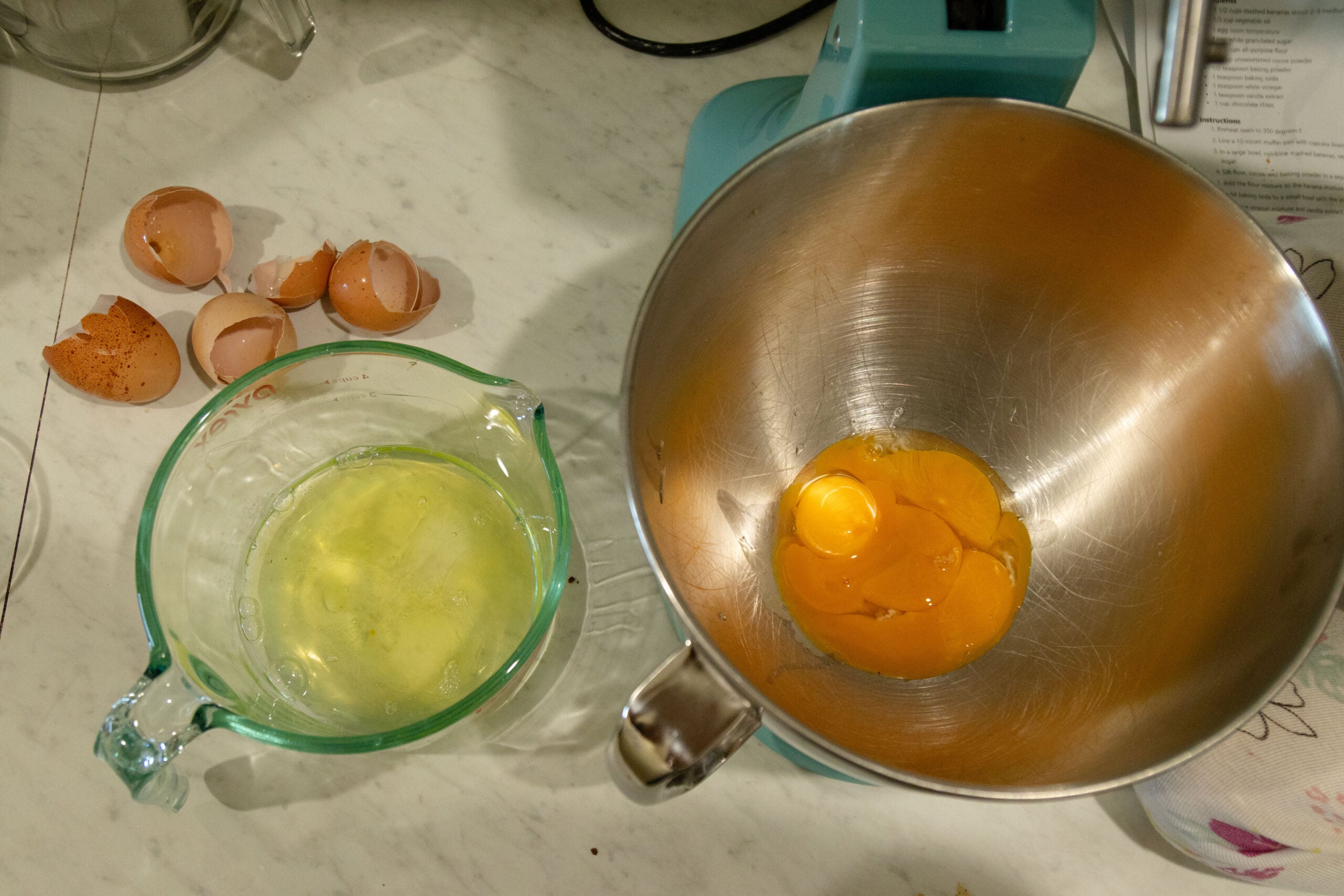 the yolks in the stand mixer bowl and the whites in another bowl