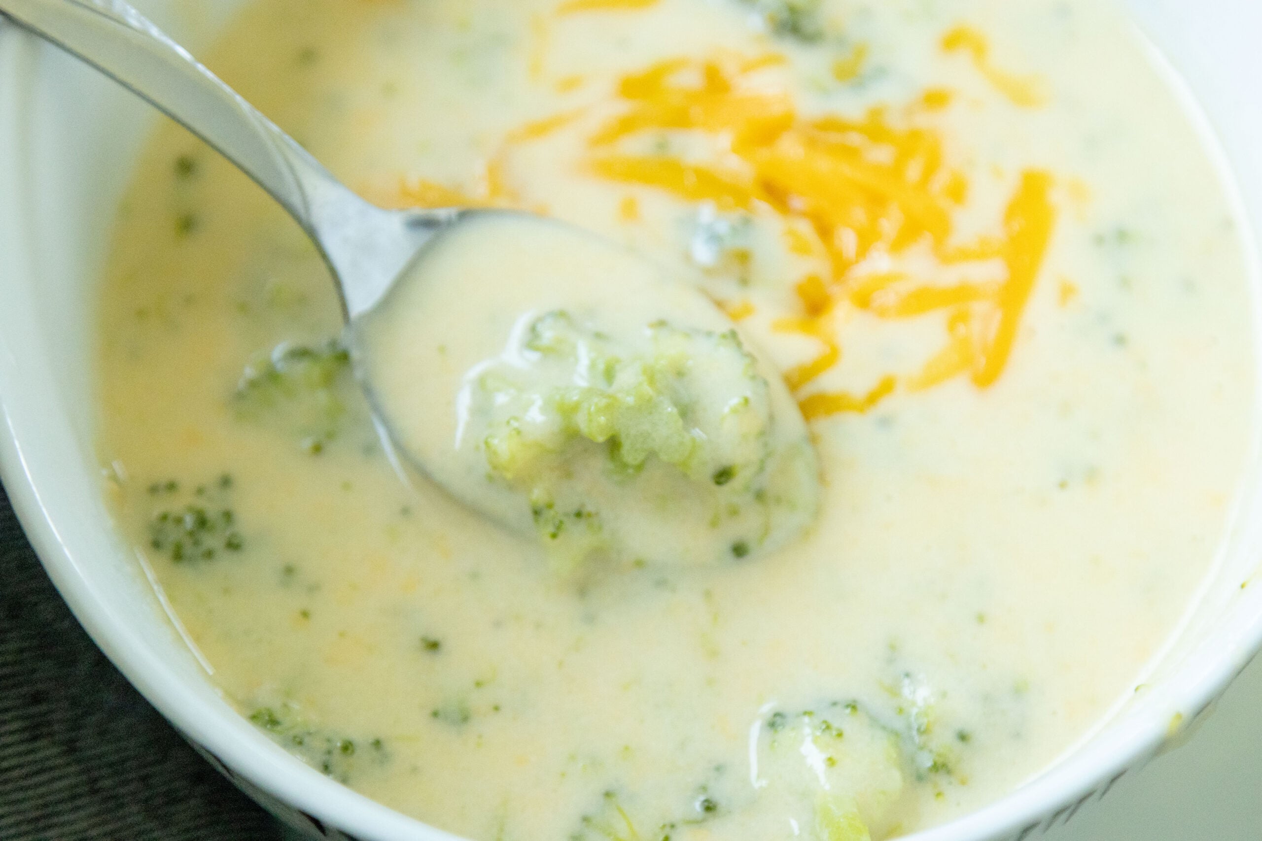 spoon scooping some broccoli cheddar soup