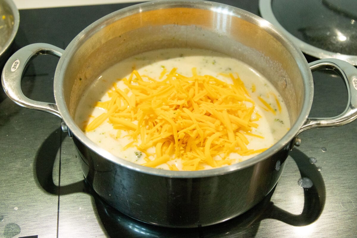 adding the cheese to the soup