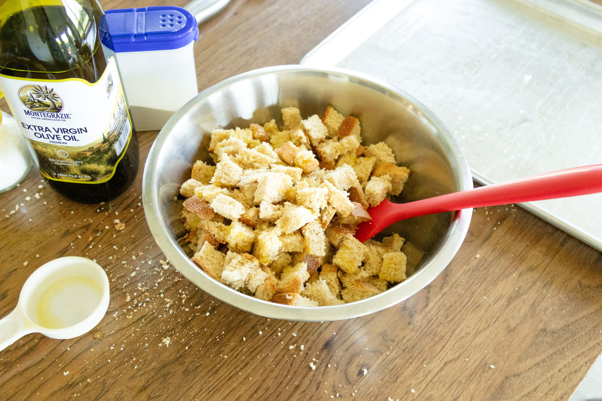 tossing the bread cubes with oil and seasonings