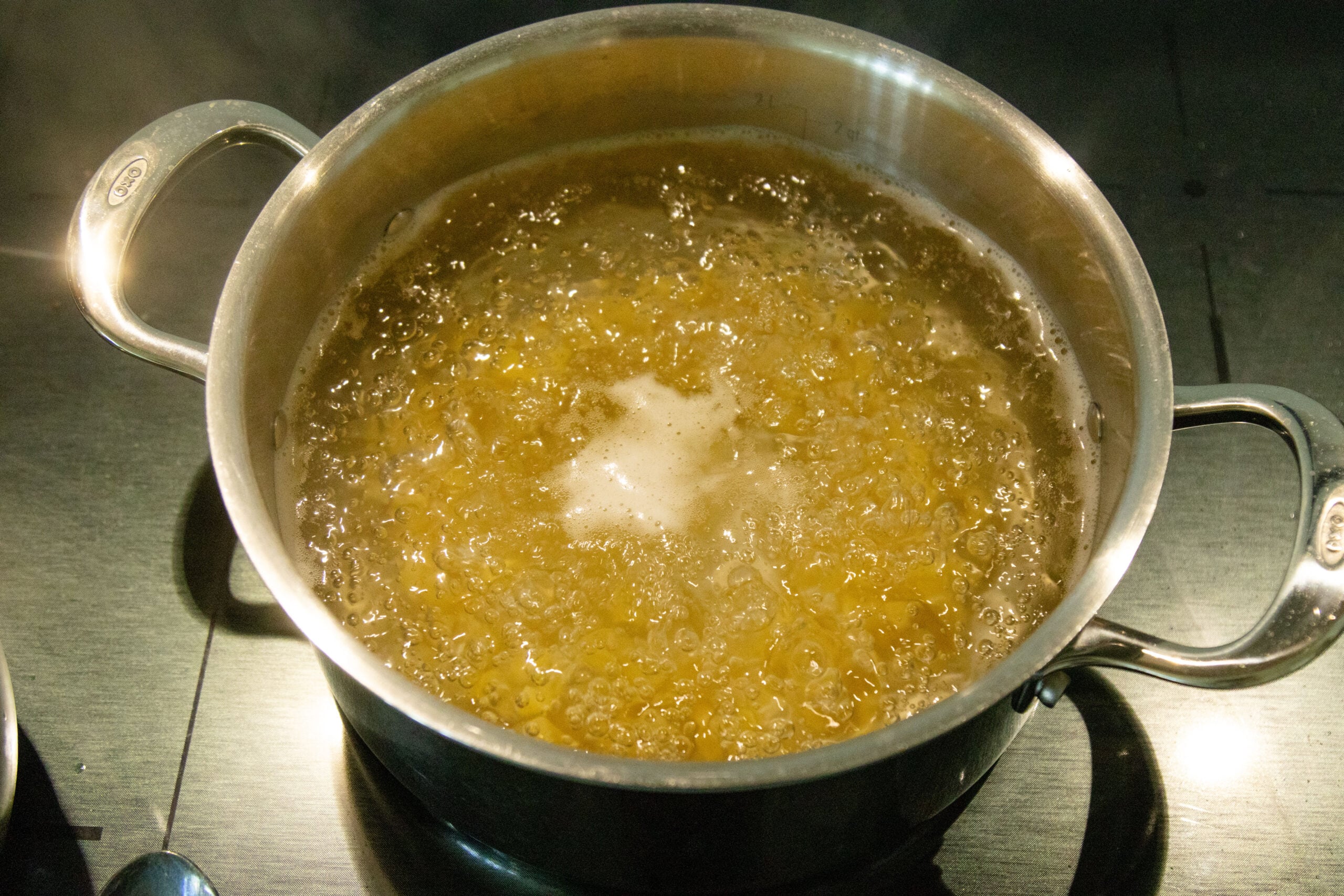 boiling the macaroni in a pot on the stove