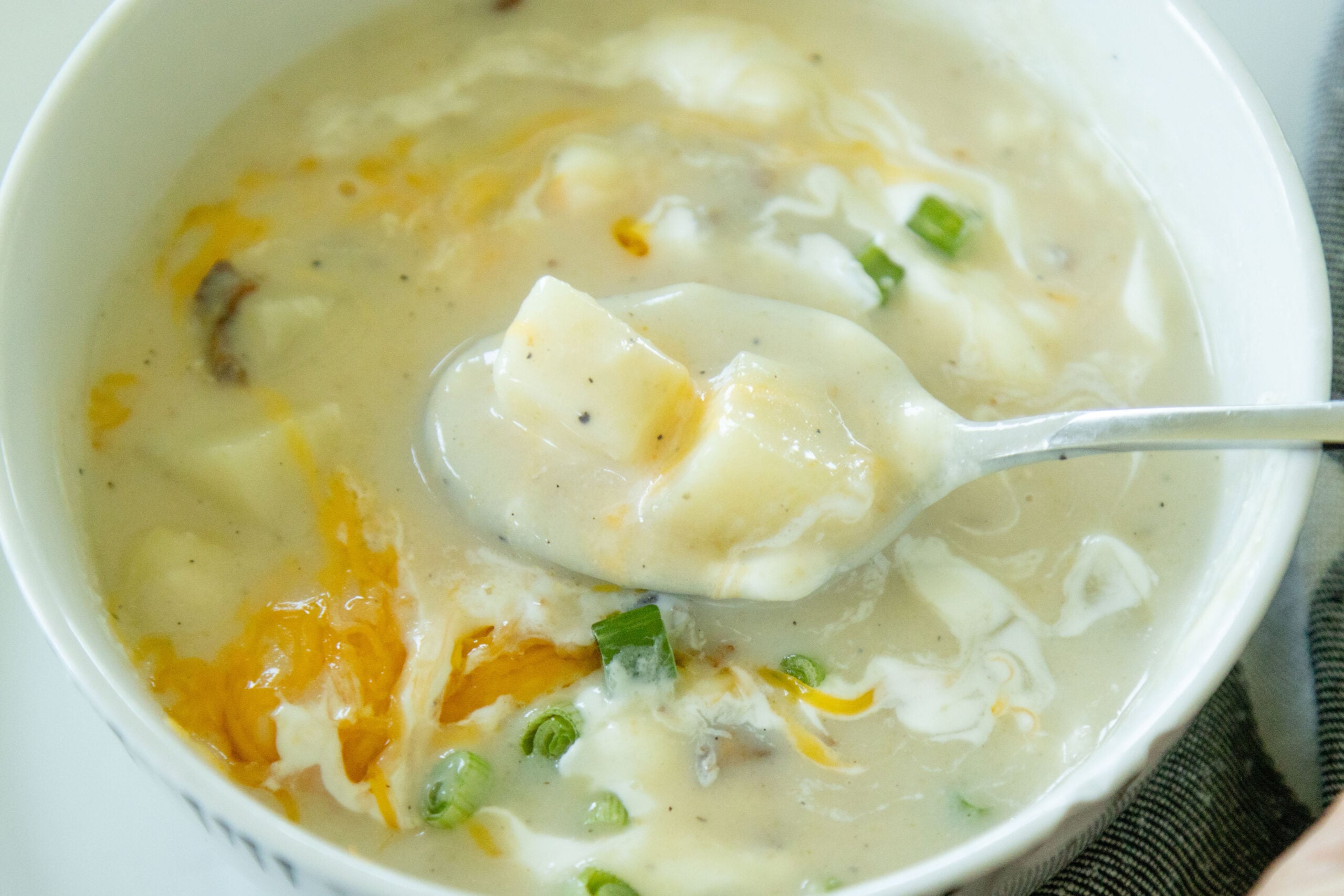spoon scooping some loaded potato soup