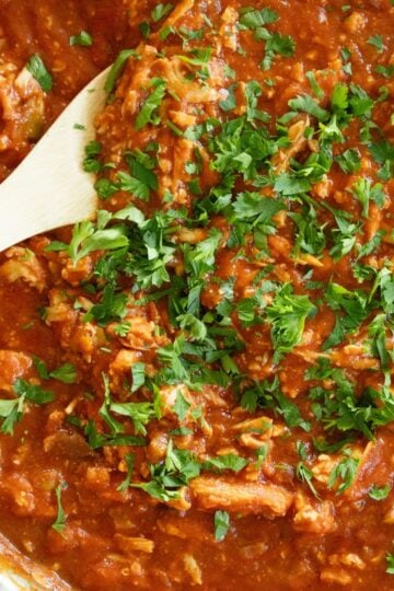wooden spoon scooping some chicken creole