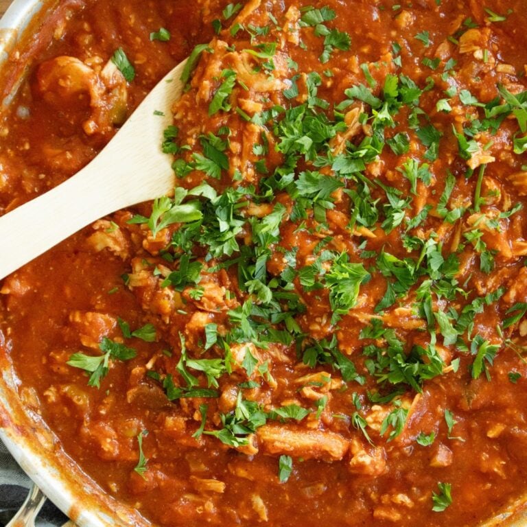 wooden spoon scooping some chicken creole