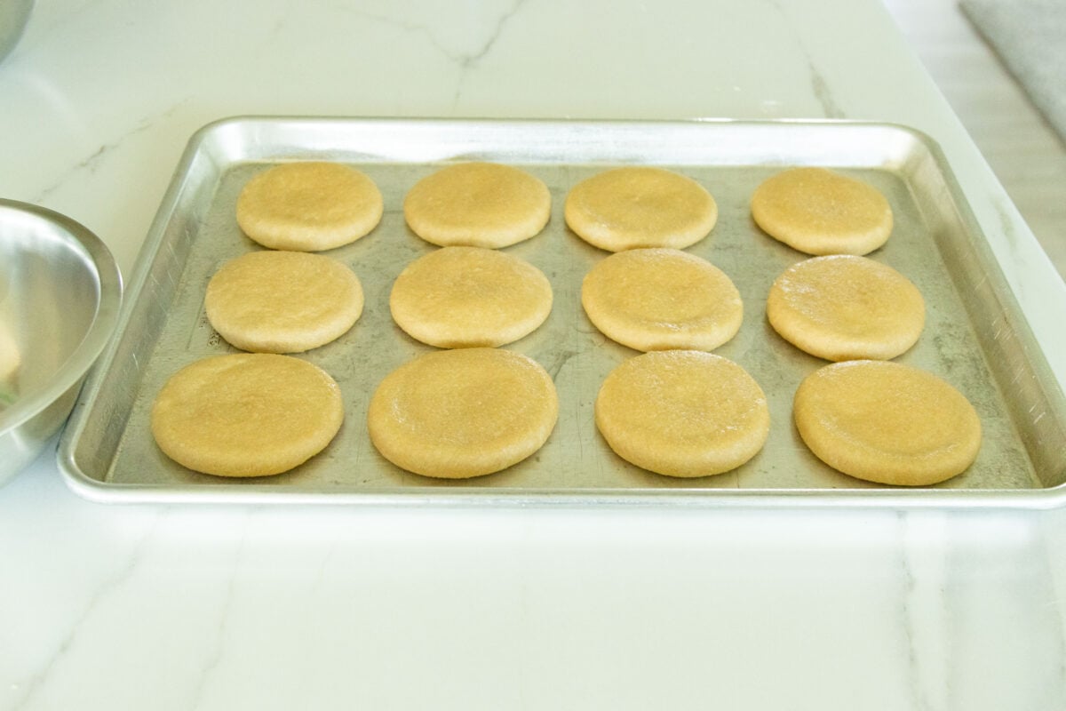 a pan of fresh milled hamburger buns ready to rise