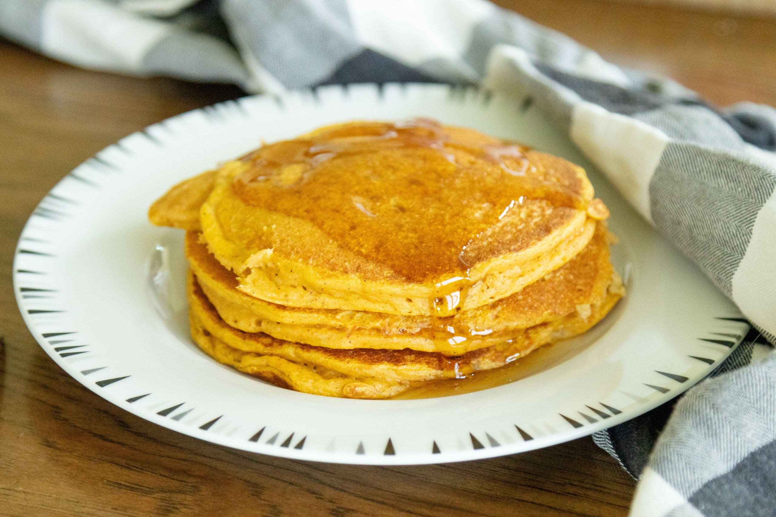 three pancakes on a white plate