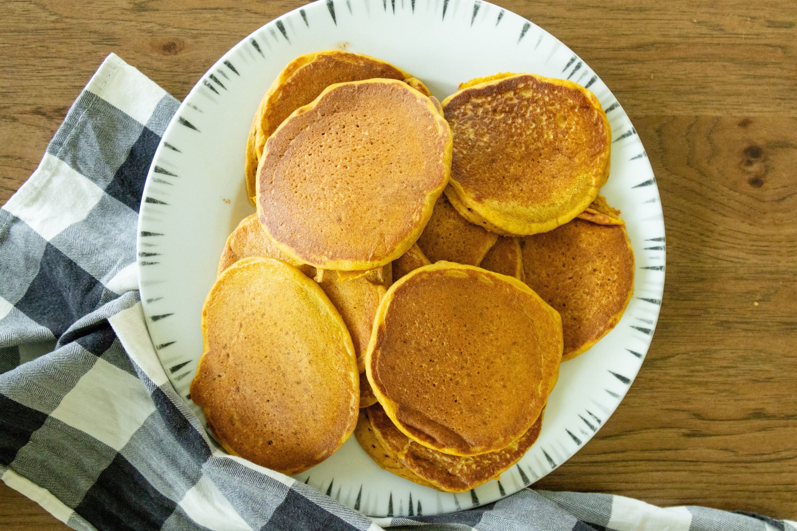 a plate full of whole wheat pumpkin pancakes