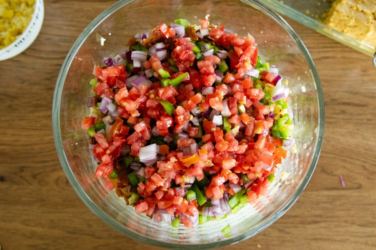 a layer of tomatoes in the salad bowl