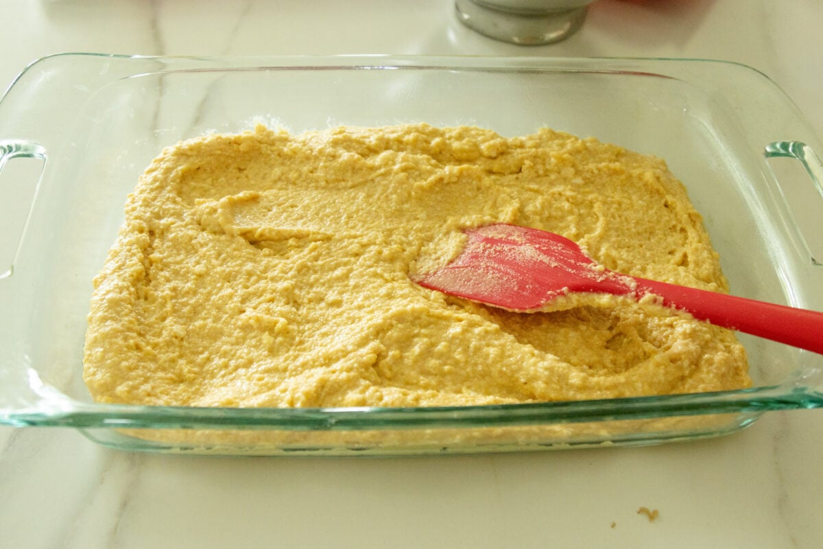 spreading the cornbread mixture into the pan