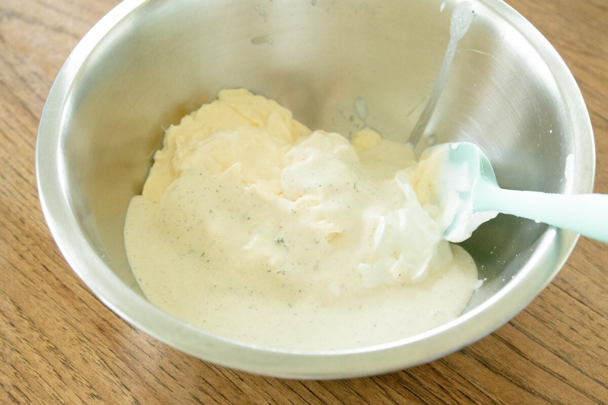 mixing the cornbread salad dressing together in a bowl