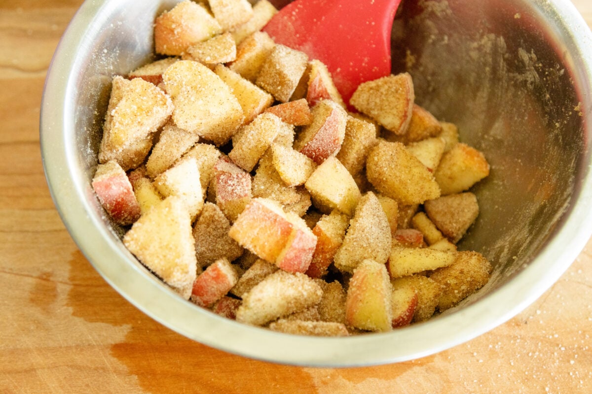 tossing the apples in cinnamon sugar