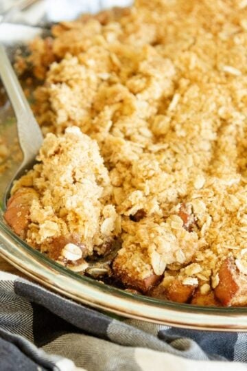 freshly baked apple crisp, with a spoon scooping some out